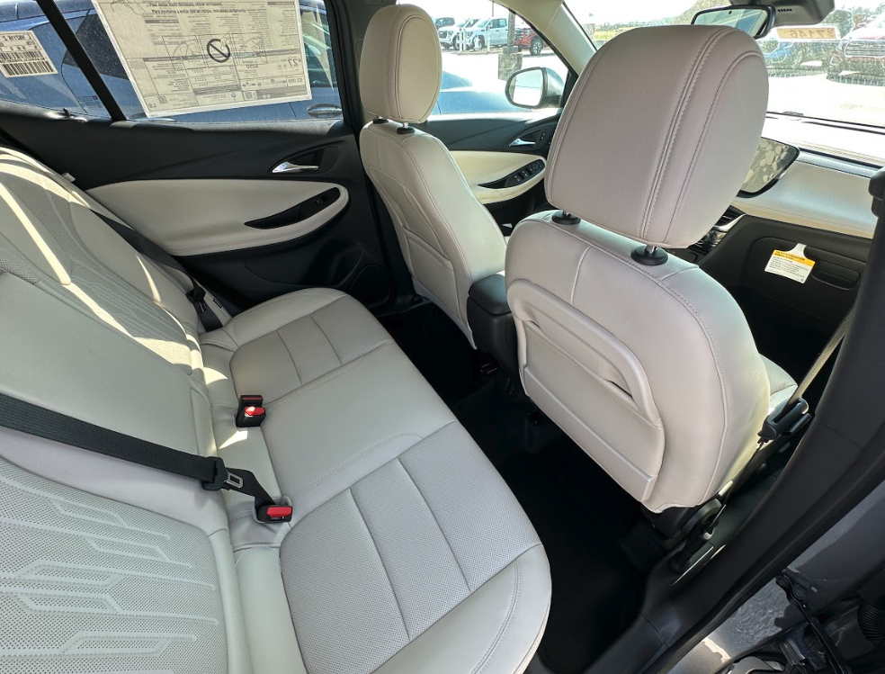 Interior of a Buick SUV showing spacious second-row seating with light-colored upholstery